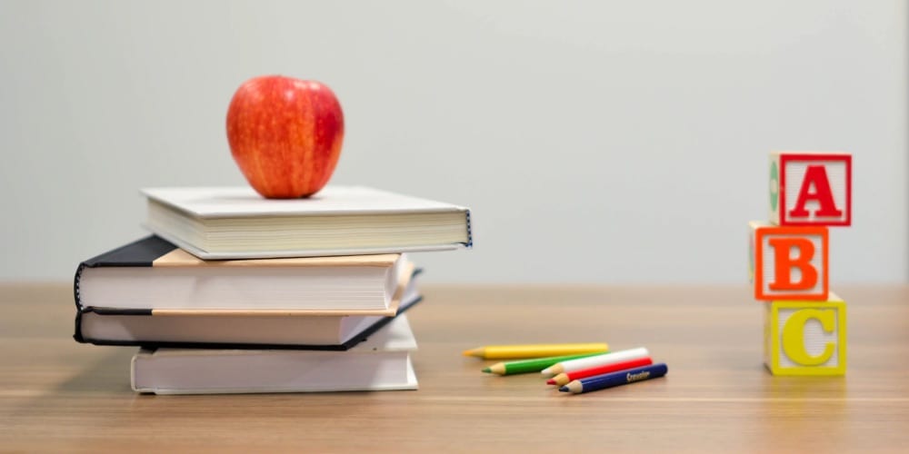 Stack of books on school desk